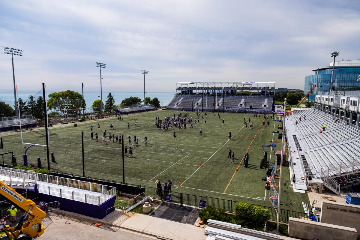 Northwestern players practice just off Lake Michigan on Aug. 12 as construction continues on their temporary playing facility on campus.