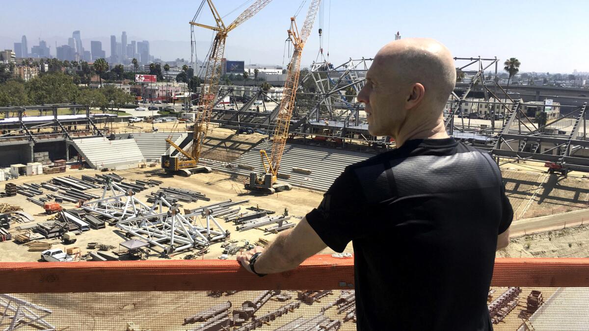 Los Angeles Football Club coach Bob Bradley takes in the view of the L.A. skyline from the roof of the team's new Banc of California Stadium in July.