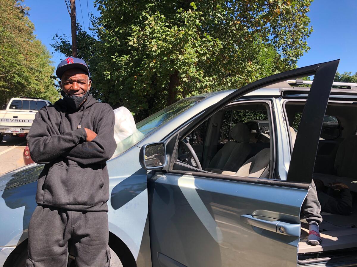 Craig McDaniel standing next to a car in Atlanta.