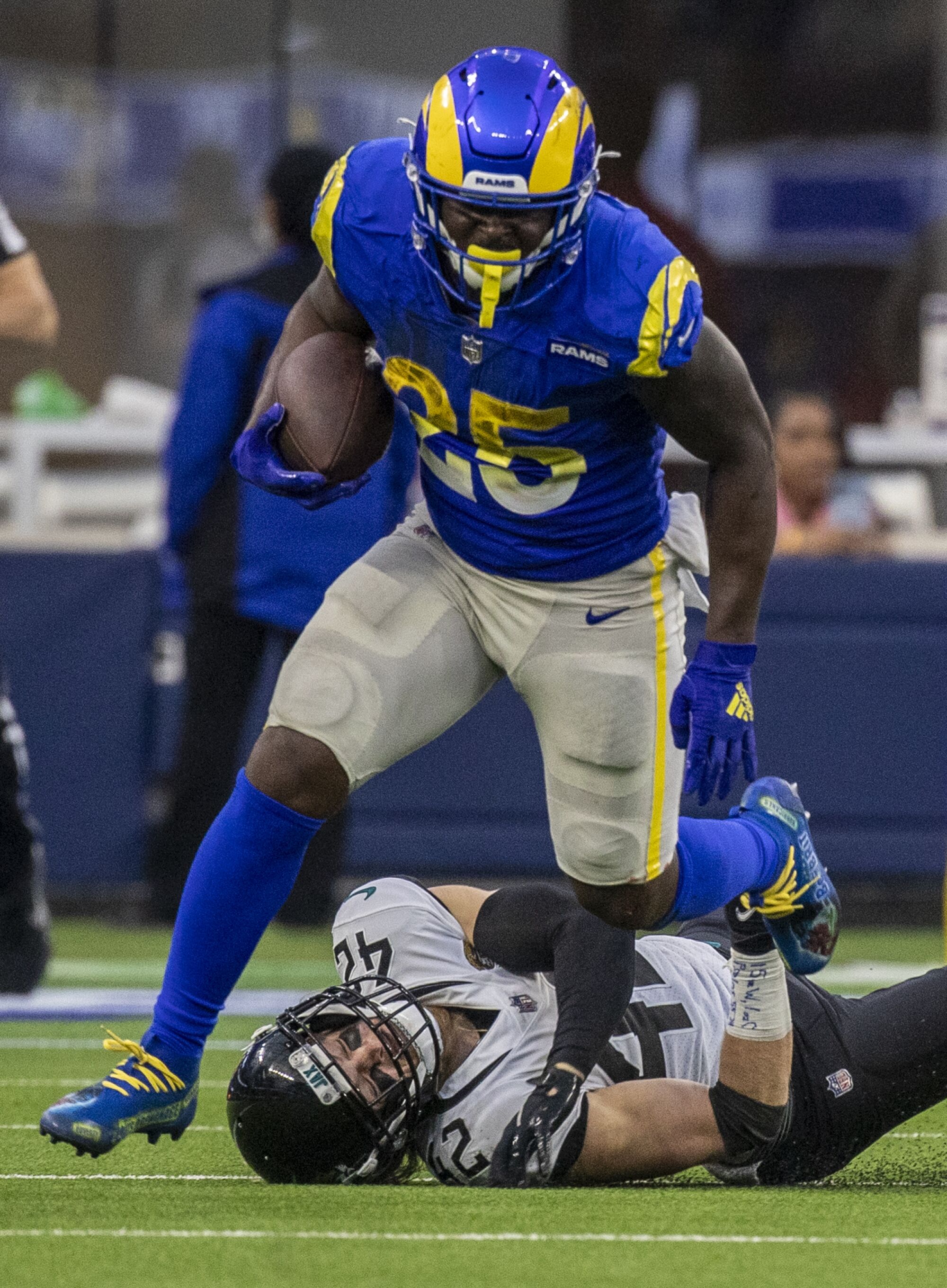 Rams running back Sony Michel, top, breaks a tackle by Jacksonville Jaguars safety Andrew Wingard.