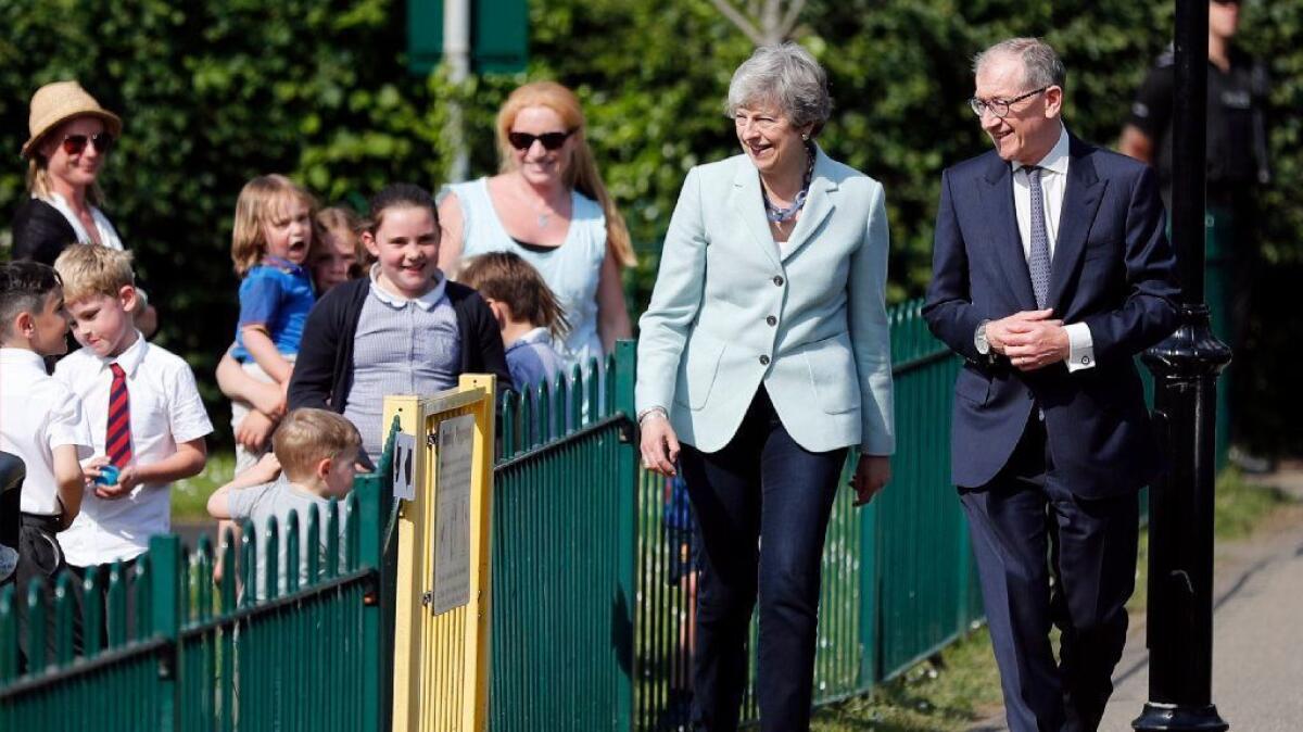 Prime Minister Theresa May and husband Philip arrive at a polling station in Sonning, England, to vote in the European elections May 23.