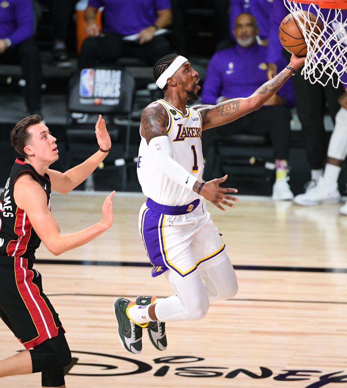 Kentavious Caldwell-Pope beats Miami's Duncan Robinson for a layup during the Lakers' title-clinching win on Oct. 11, 2020.