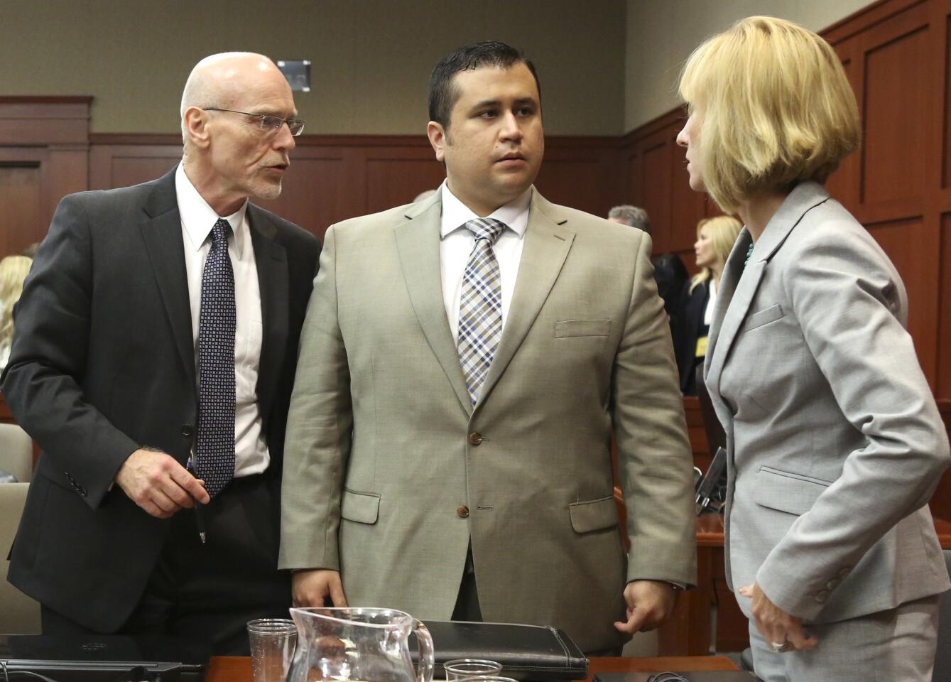 Don West, left, and Lorna Truett, talk with their client George Zimmerman during his trial in Seminole circuit court in Sanford, Fla. Tuesday, June 25, 2013. Zimmerman has been charged with second-degree murder for the 2012 shooting death of Trayvon Martin. (Gary W. Green/Orlando Sentinel)