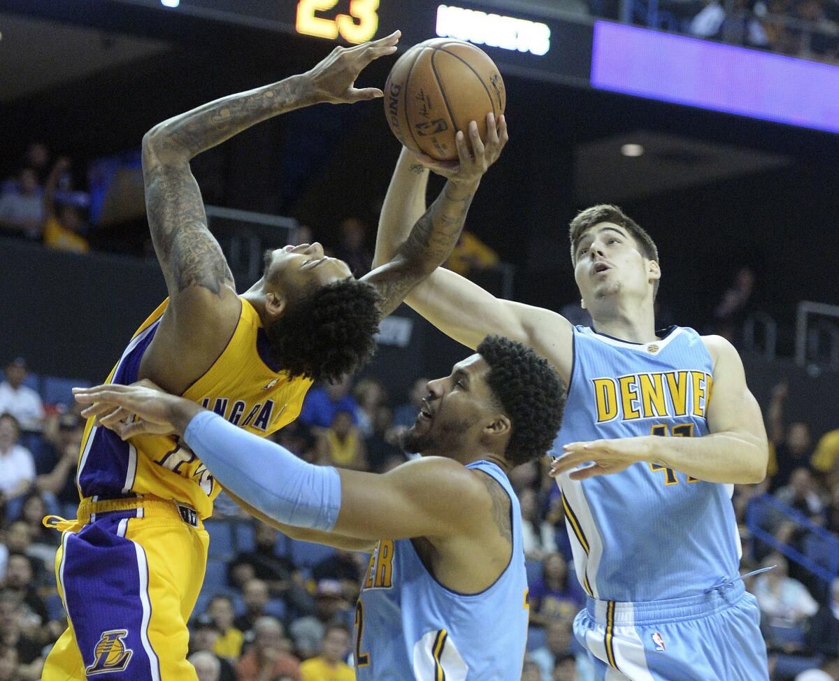 Lakers forward Brandon Ingram has the ball stripped away by Nuggets forward Juancho Hernangomez, right, during the first half of a preseason game in Ontario on Oct. 9.