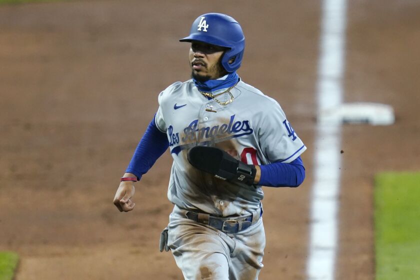 Los Angeles Dodgers' Mookie Betts scores against the Seattle Mariners.