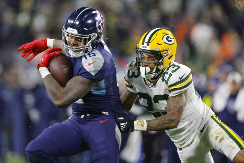 Tennessee Titans wide receiver Treylon Burks (16) catches a pass in front of Green Bay Packers cornerback Jaire during an NFL football Thursday, Nov. 17, 2022, in Green Bay, Wis. (AP Photo/Jeffrey Phelps)
