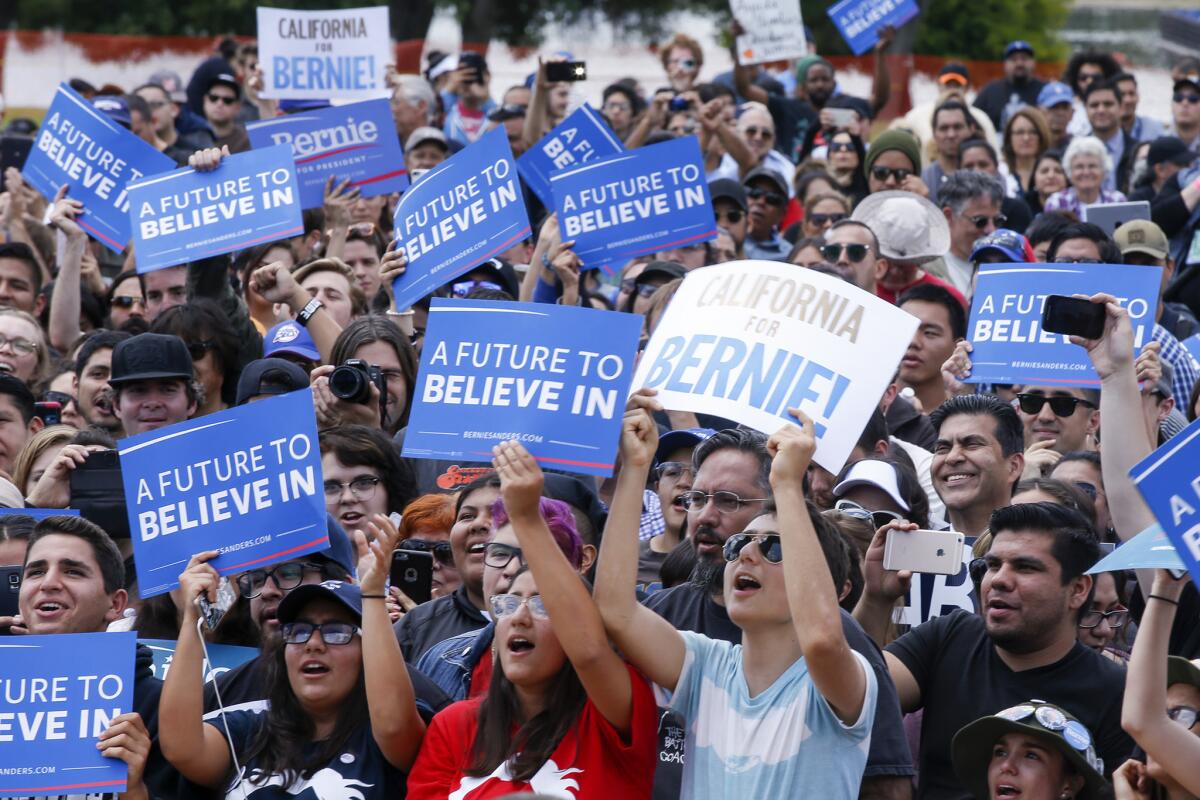 Democratic presidential candidate Bernie Sanders gets a round of applause during a rally at Lincoln Park in East Los Angeles.