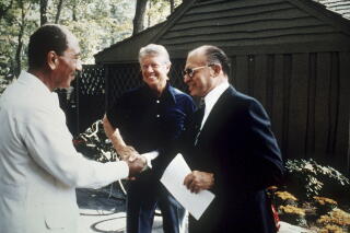 Egyptian President Anwar Sadat, left, Israeli Prime Minister Menachem Begin and President Carter at Camp David