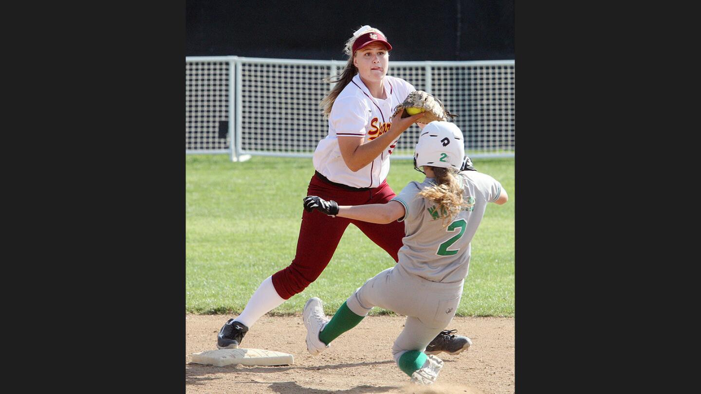 La Cañada's shortstop Emily Tinkham touches second base for the force-out to Monrovia's Blair Walters and prepares to throw to first for a double play attempt in a Rio Hondo League softball game at La Cañada High School on Friday, March 24, 2017.