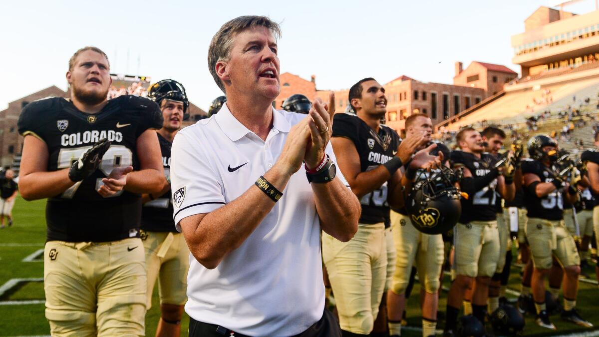 Colorado Coach Mike MacIntyre and his players sing along with the band after a 56-7 win over Idaho State on Sept. 10.