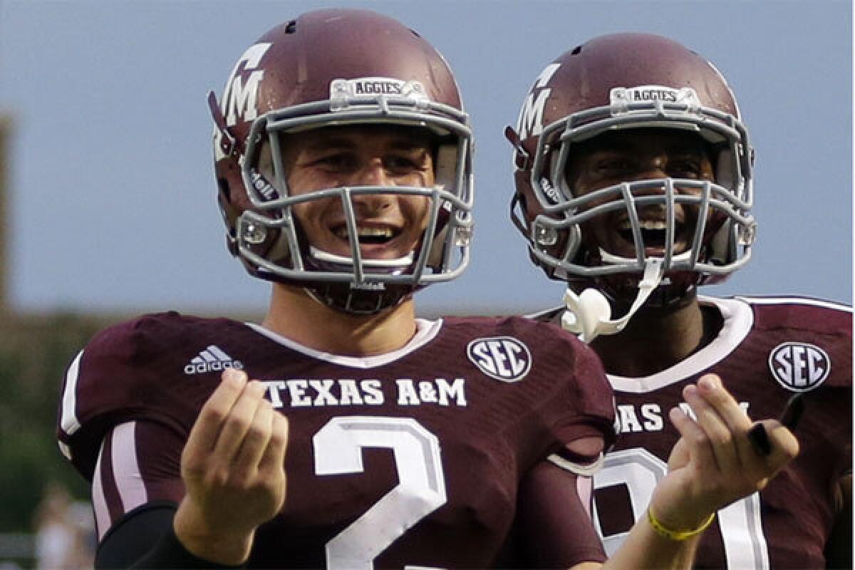 Texas A&M; quarterback Johnny Manziel celebrates after throwing a touchdown pass against Sam Houston State on Saturday.