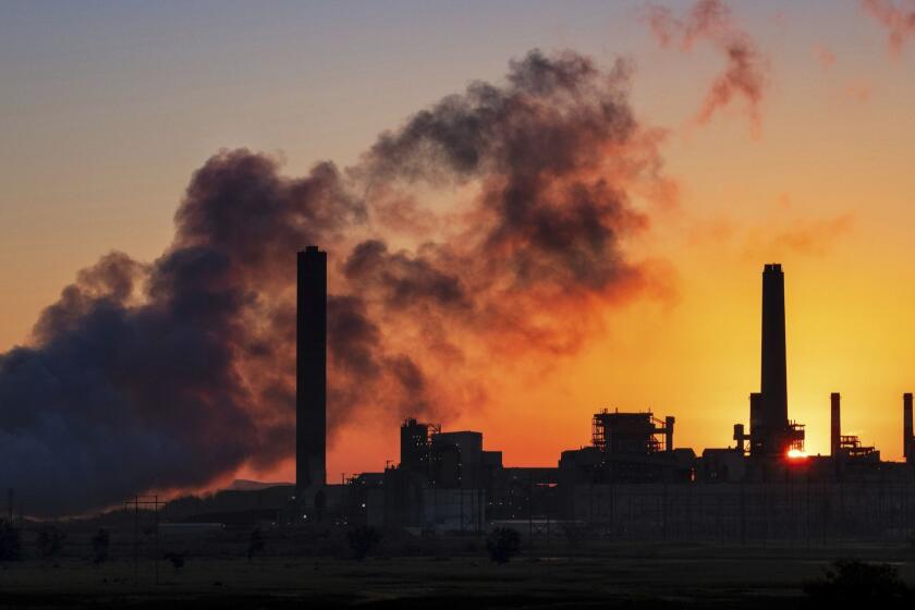 In this July 27, 2018, photo the Dave Johnson coal-fired power plant is silhouetted against the morning sun in Glenrock, Wyo. (AP Photo/J. David Ake)