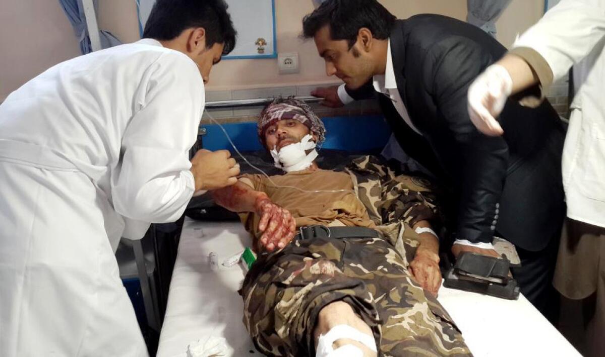 Afghan medical staff help an injured man at a hospital after a suicide attack in Faryab province on July 22.