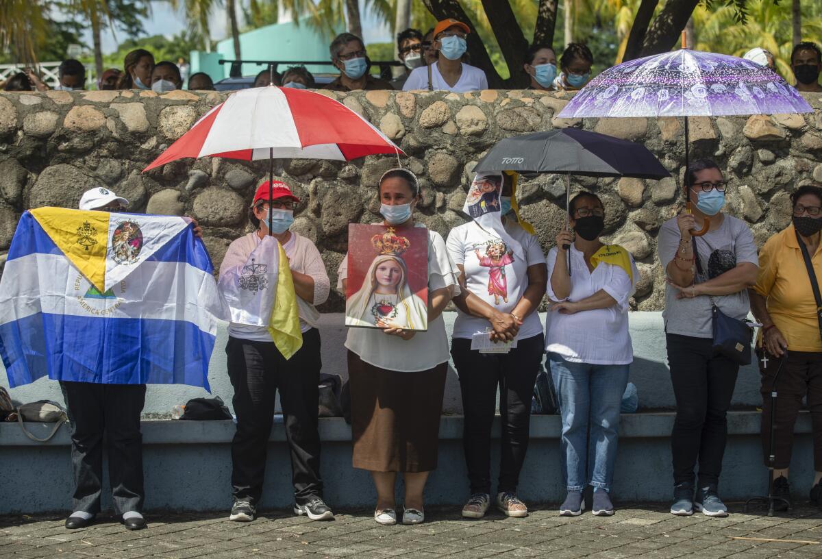 Faithful take part in a procession in Managua, Nicaragua, Saturday, Aug. 13, 2022. The Catholic Church has called on the faithful to peacefully arrive at the Cathedral in Managua Saturday after National Police denied permission for a planned religious procession on “internal security” grounds. (AP Photo)