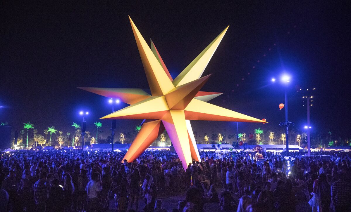 Festival goers crowd around the Supernova, a polychromatic star during the 2018 Coachella Valley Music and Arts Festival 