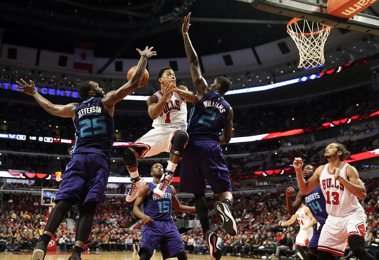 Bulls guard Derrick Rose has the ball stripped away by Charlotte Hornets center Al Jefferson during the Bulls' 101-96 preseason win at United Center Sunday.