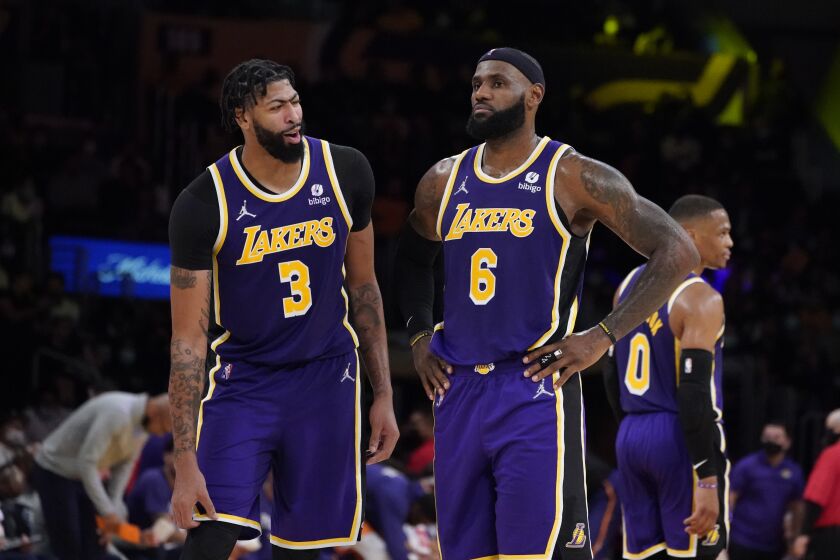 Los Angeles Lakers forward LeBron James (6) stands next to forward Anthony Davis during the second half of an NBA basketball game against the Phoenix Suns Friday, Oct. 22, 2021, in Los Angeles. (AP Photo/Marcio Jose Sanchez)