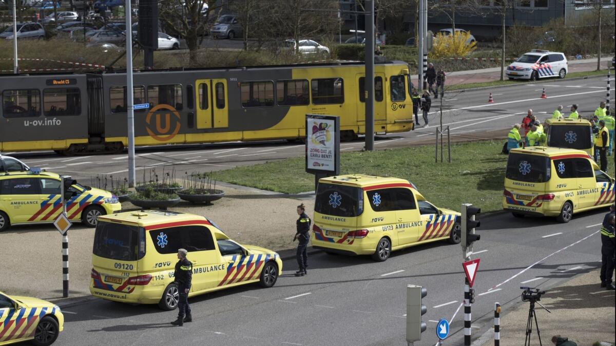 Ambulances are parked next to a tram after a gunman opened fire, killing three, in Utrecht, Netherlands, on Monday.