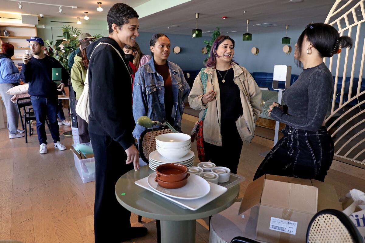 People wait in line to purchase their merchandise at the Wing in West Hollywood.