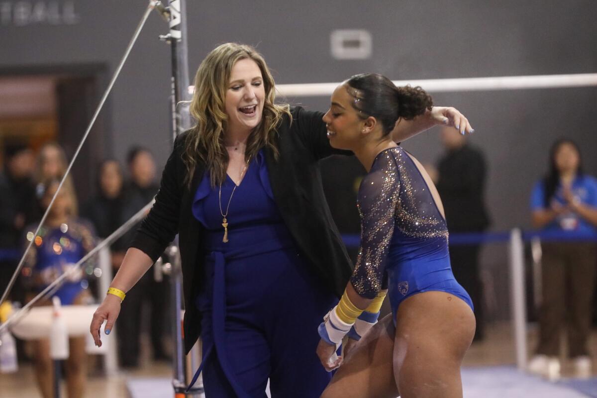 UCLA coach Janelle McDonald congratulates Margzetta Frazier after she competed at the NCAA Los Angeles Regional