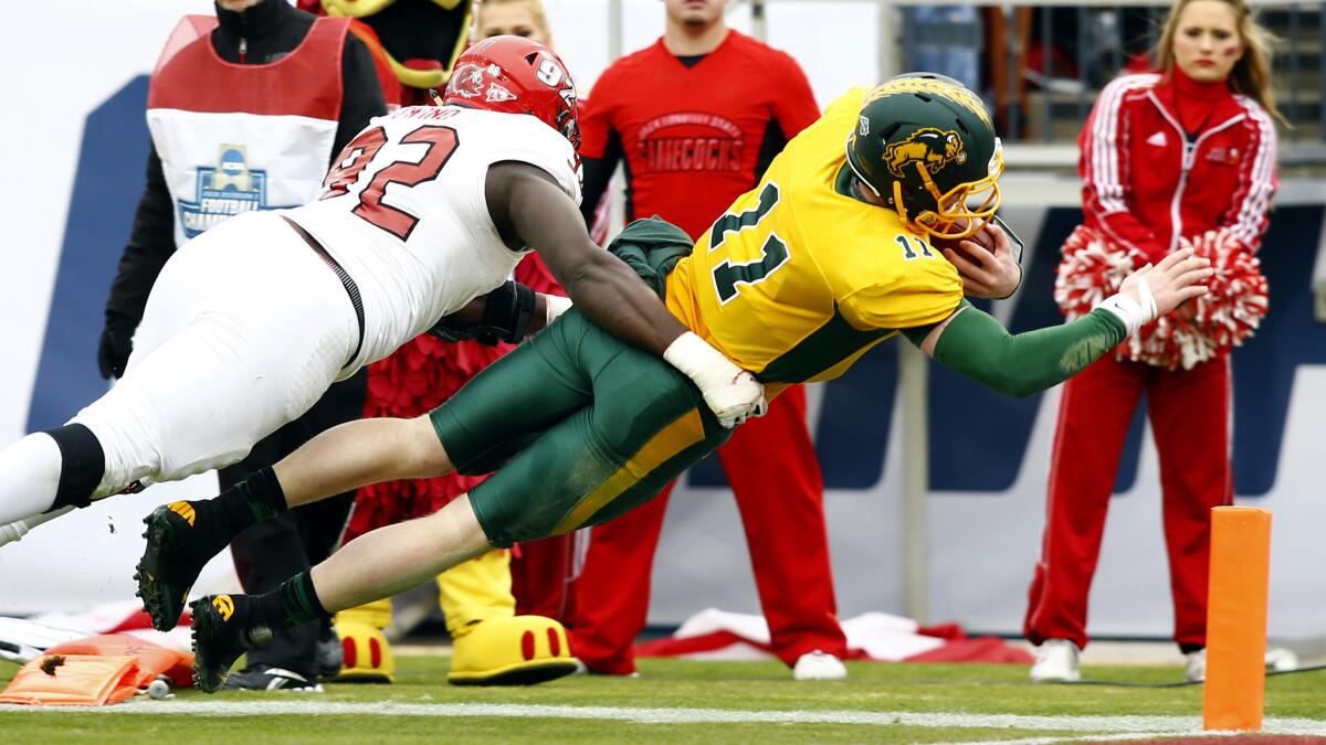 North Dakota State quarterback Carson Wentz (11) dives for a touchdown before Jacksonville State defensive lineman Desmond Owino (92) can tackle him on Saturday.