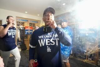 Los Angeles Dodgers manager Dave Roberts celebrates with others after the Dodgers.