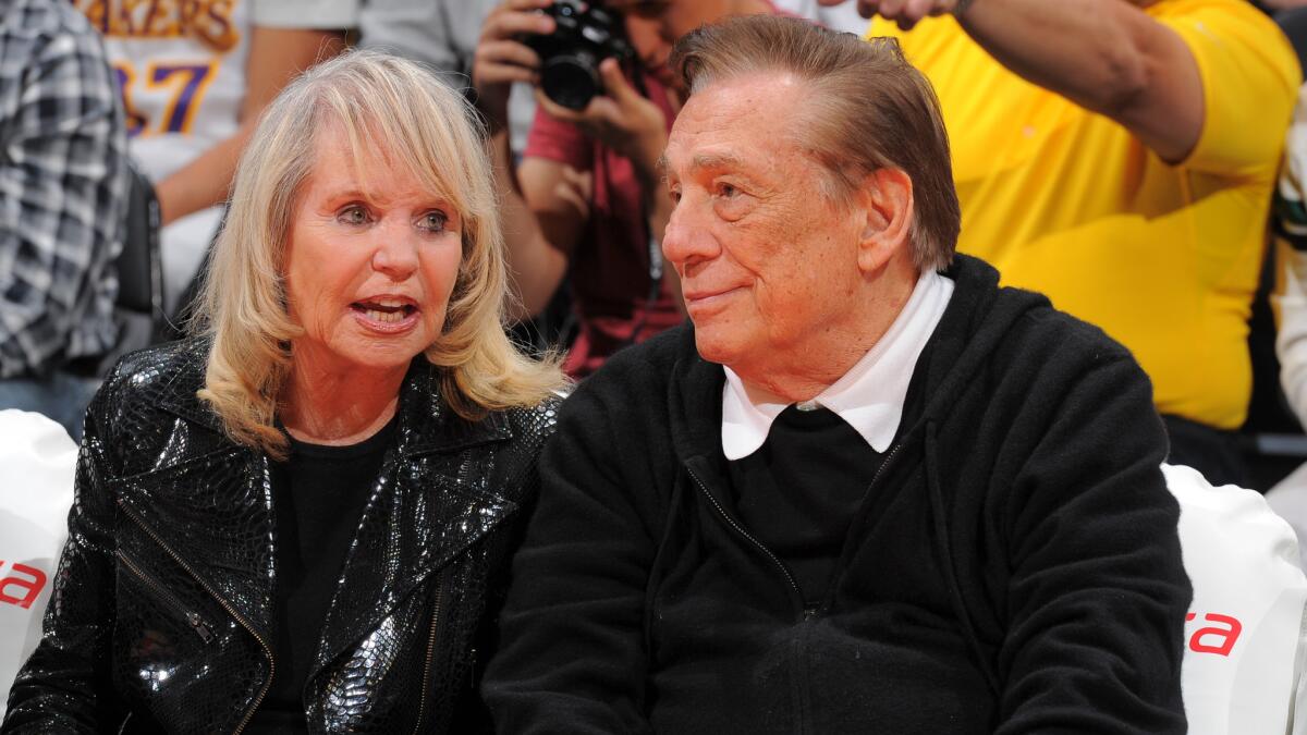 Clippers owners Donald and Shelly Sterling attend a game against the Indiana Pacers in April 2013. The Sterlings need to give up their efforts to keep the team.