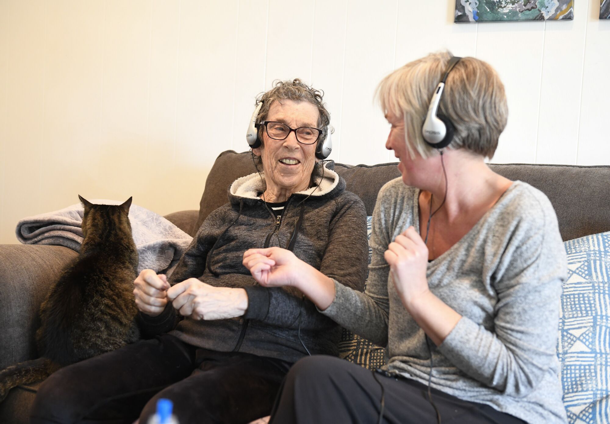 Stacey Skrocki, volunteer with Jewish Family Service, right and Gloria Wasserman move to the music as they do in-home music and memory therapy Monday, Dec. 9, 2019 in San Diego, California. (Photo by Denis Poroy/Union-Tribune)