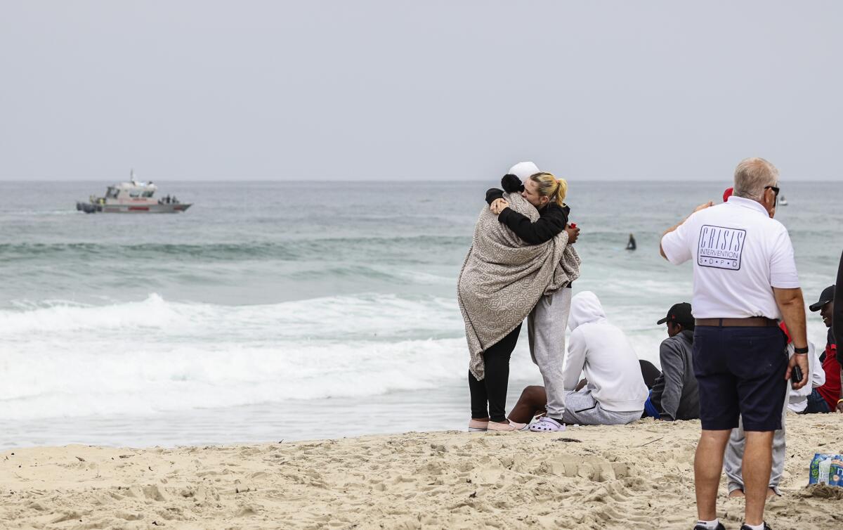 Family and friends of a missing 18-year-old swimmer gathered Wednesday at Mission Beach as lifeguards searched for his body.