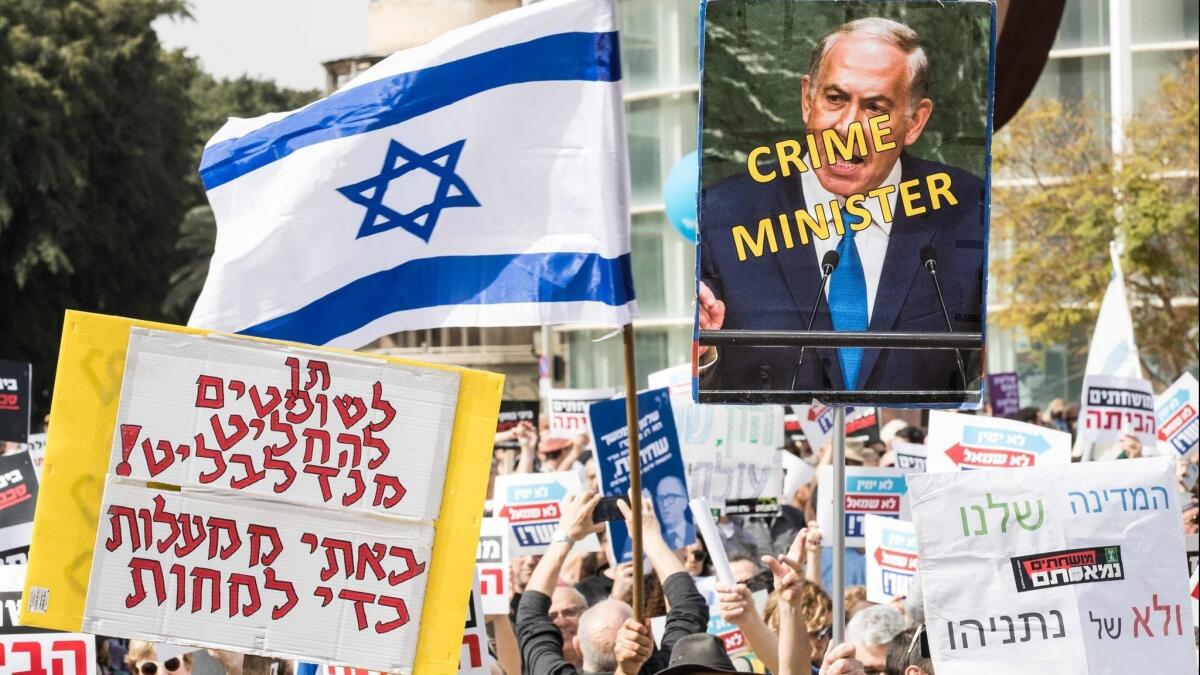 Israelis protest against Prime Minister Benjamin Netanyahu in February 2018 after police recommended that he be indicted on corruption charges.