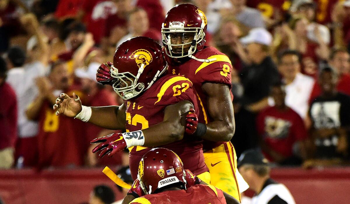 USC's JuJu Smith-Schuster (9) celebrates his touchdown with Khaliel Rodgers (62) and Justin Davis (22) to take a 42-17 lead over the Utah Utes during the fourth quarter on Saturday.