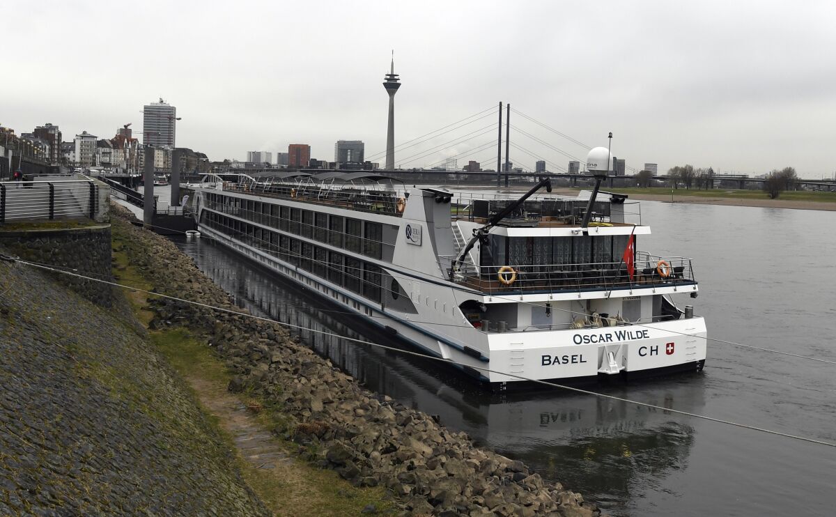 The hotel ship Oscar Wilde, which is used as accommodation for refugees, lies on the banks of the Rhine in Duesseldorf, Germany, Tuesday, March 15, 2022. A young woman has been raped on a ship. Two suspects have been arrested, said a police spokesman on Tuesday morning on request. The crime had already occurred on March 6. The German government said Wednesday that it would seek to ensure refugees fleeing conflicts in Ukraine and elsewhere don’t become victims of crime following a reported rape case that has prompted a public outcry. (Roberto Pfeil/dpa via AP)