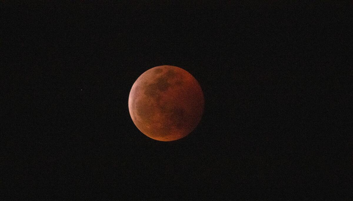 The super blood moon is engulfed into Earth's dark umbral shadow during a total lunar eclipse.