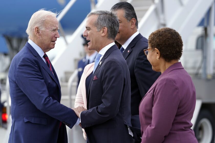 President Joe Biden greets, from front right, Rep. Karen Bass, D-Calif., Los Angeles Mayor Eric Garcetti, Sen. Alex Padilla, D-Calif., and his wife Angela Padilla, after arriving on Air Force One at Los Angeles International Airport, Wednesday, Oct. 12, 2022. (AP Photo/Carolyn Kaster)