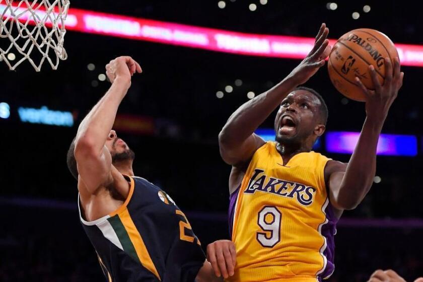 Lakers forward Luol Deng drives to hoop against Utah center Rudy Gobert during a game on Dec. 27.