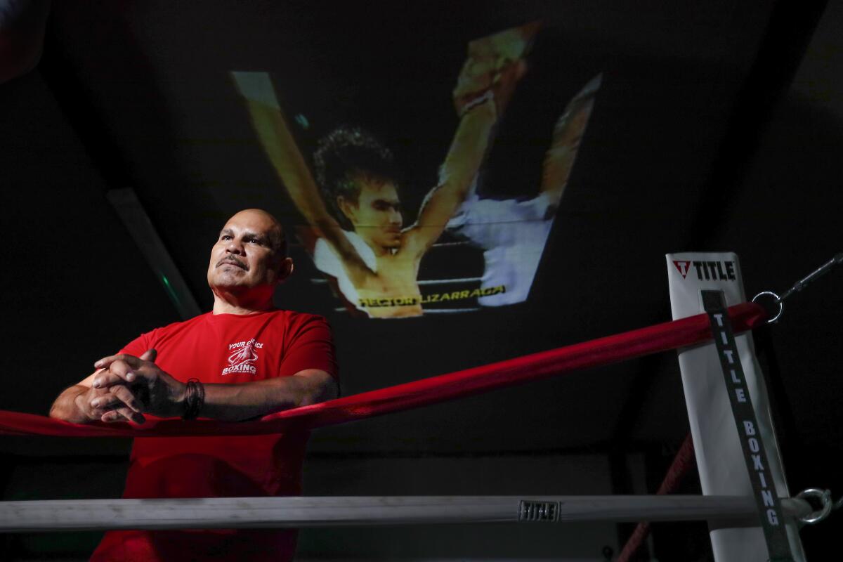 Hector Lizarraga, a retired featherweight from Mexico, stands in a boxing ring. 