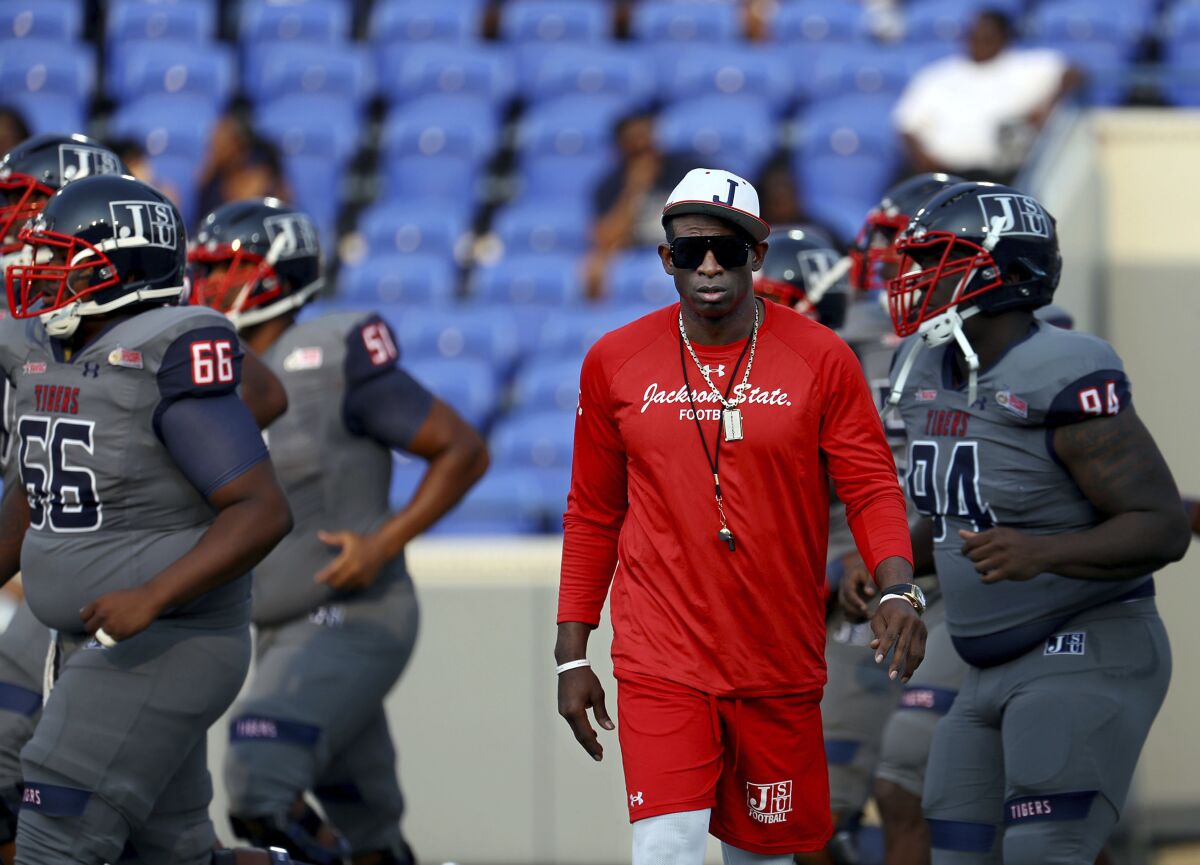 Jackson State head coach Deion Sanders works with his players before the Southern Heritage Classic NCAA college football game against Tennessee State in Memphis, Tenn., Saturday, Sept. 11, 2021. (Patrick Lantrip/Daily Memphian via AP)