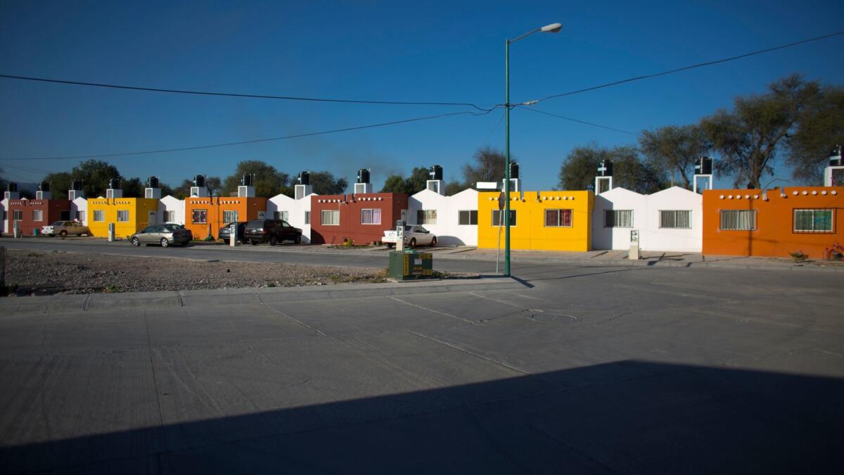 Homes in the newly constructed "La Esperanza" gated community, which advertises homes for workers using government real estate loans, in Villa de Reyes, Mexico.