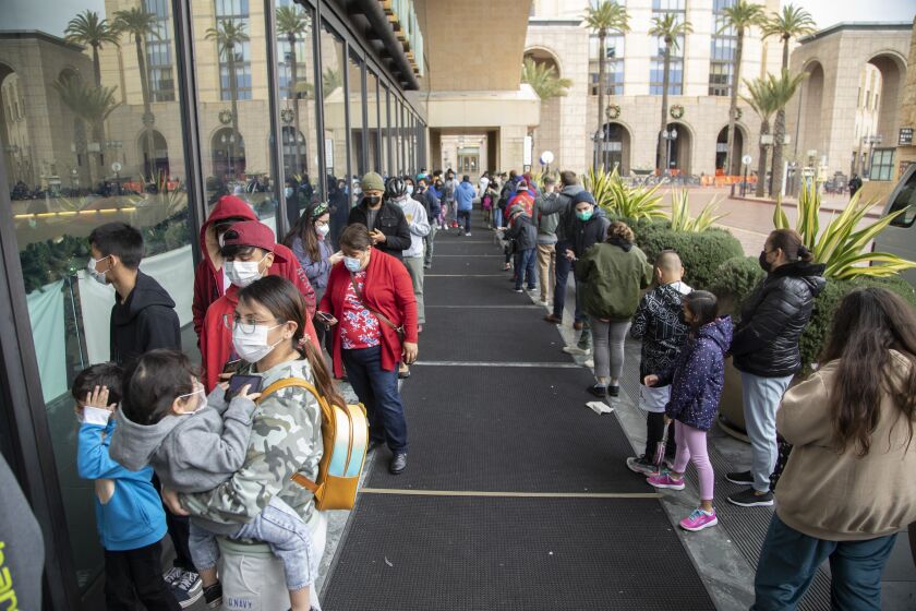 LOS ANGELES, CA - DECEMBER 27: People wait in line to get the COVID-19 test at Union Station on Monday, Dec. 27, 2021. In L.A. County, new coronavirus cases are dramatically increasing. (Myung J. Chun / Los Angeles Times)