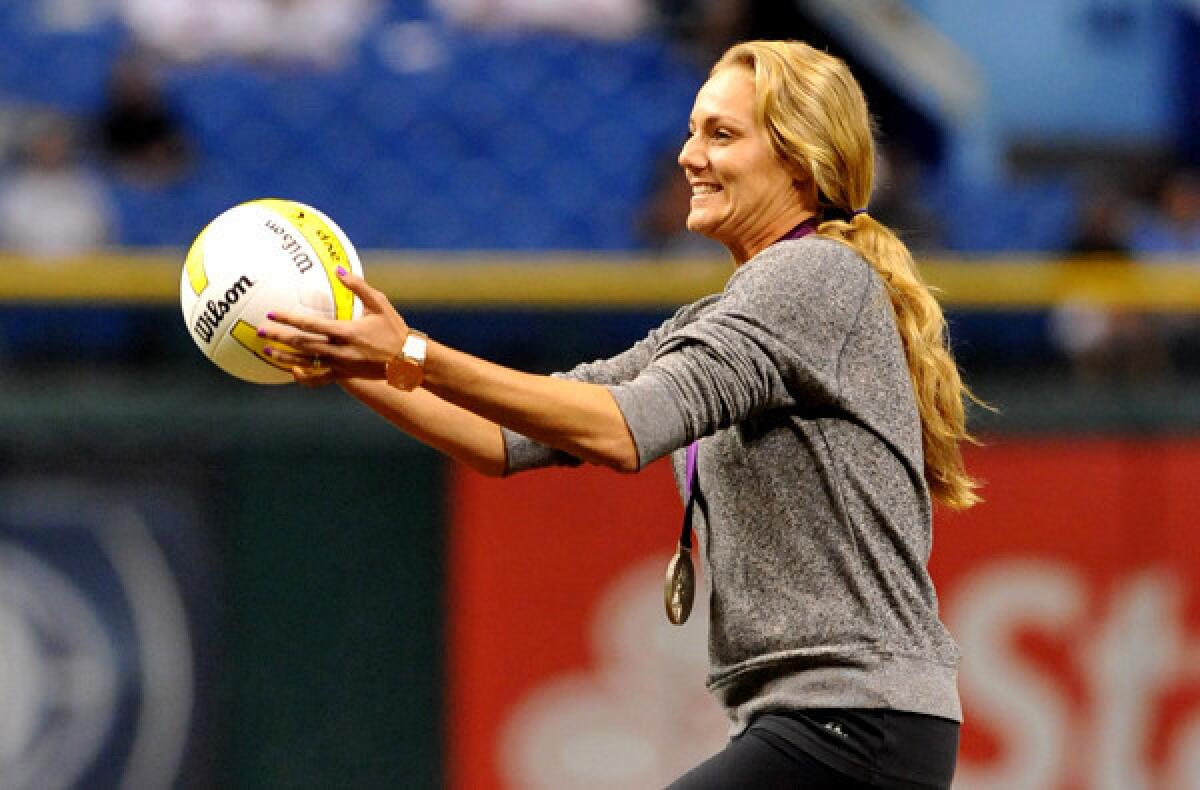 Beach volleyball star Jen Kessy, wearing her Olympic medal, takes the mound to serve up the ceremonial first pitch before the Rays-Red Sox game last month in Tampa, Fla.