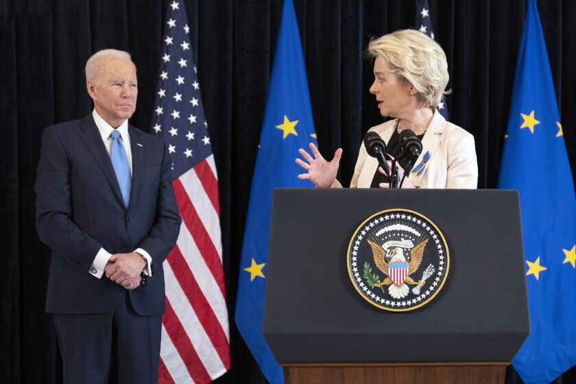 President Joe Biden listens as European Commission President Ursula von der Leyen speaks about the Russian invasion of Ukraine, at the U.S. Mission in Brussels, Friday, March 25, 2022, in Brussels. (AP Photo/Evan Vucci)