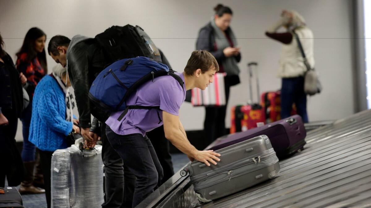 A traveler gathers his luggage at San Francisco International Airport. U.S.-based airlines reported the lowest rate of lost or mishandled luggage since the data were first collected in 1987.