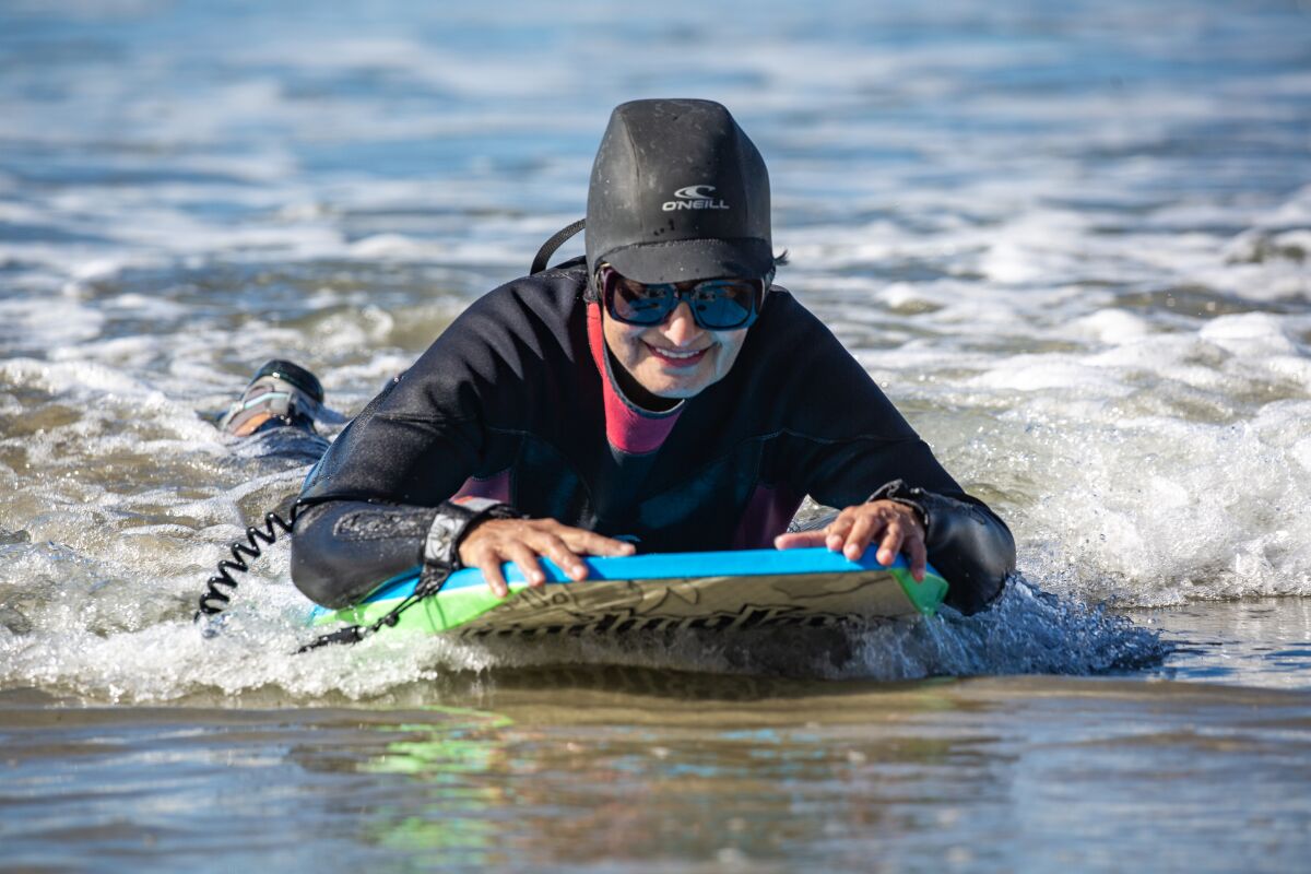 Nazlin Kassamali, a member of the Newcomers Club of San Dieguito's Boogie Board group, rides a wave.