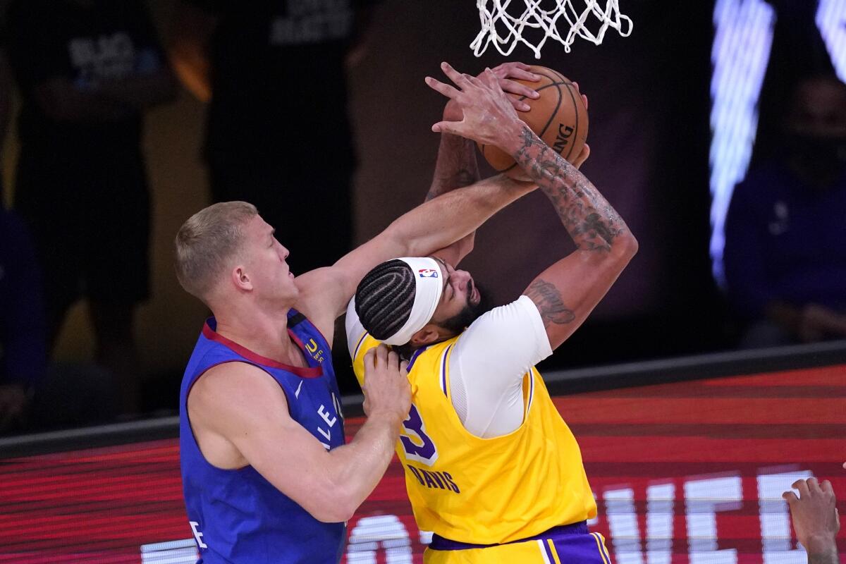 Nuggets center Mason Plumlee fouls Lakers forward Anthony Davis during a rebound in the first half of Game 1.