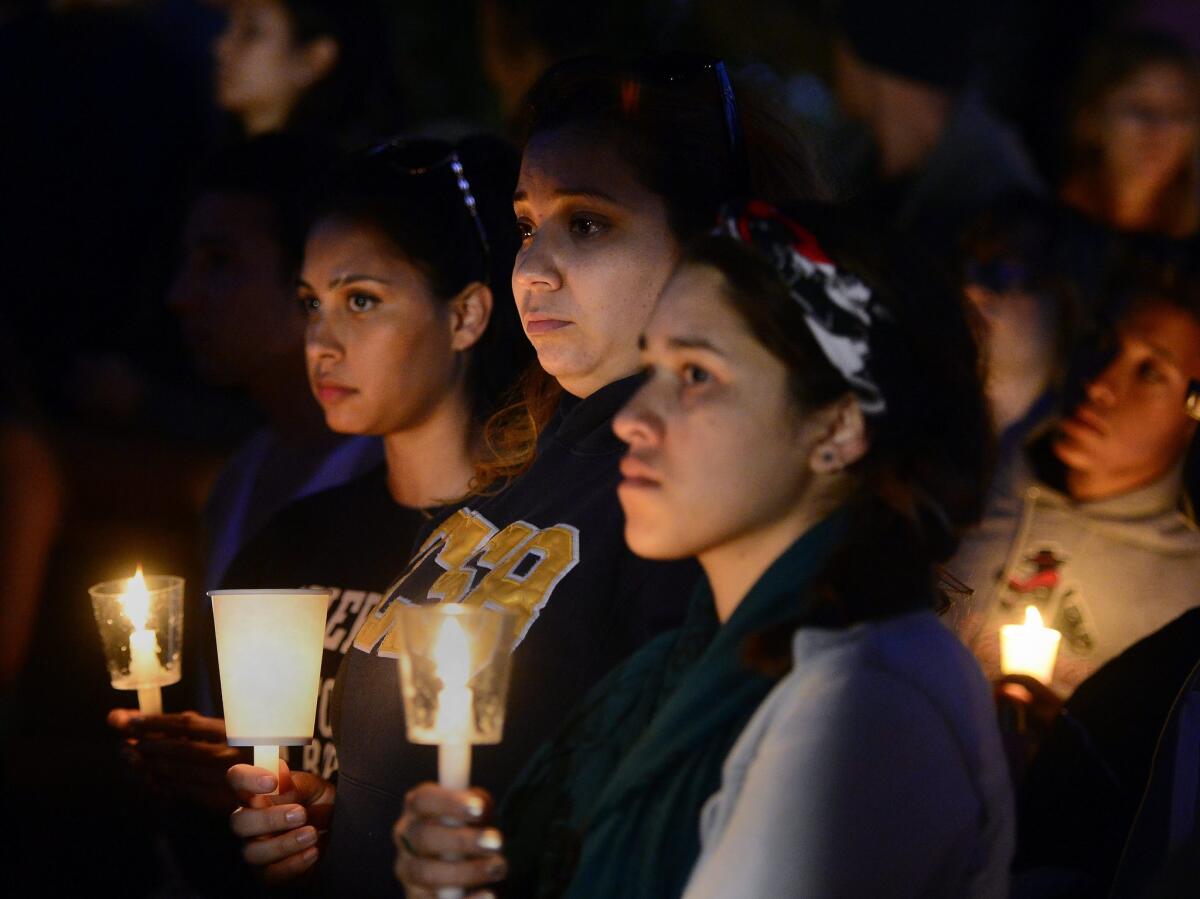 Students hold candles at a vigil in Anisq'Oyo' Park in Isla Vista, near UC Santa Barbara, on May 24, the day after a killing rampage left six people and the attacker dead.