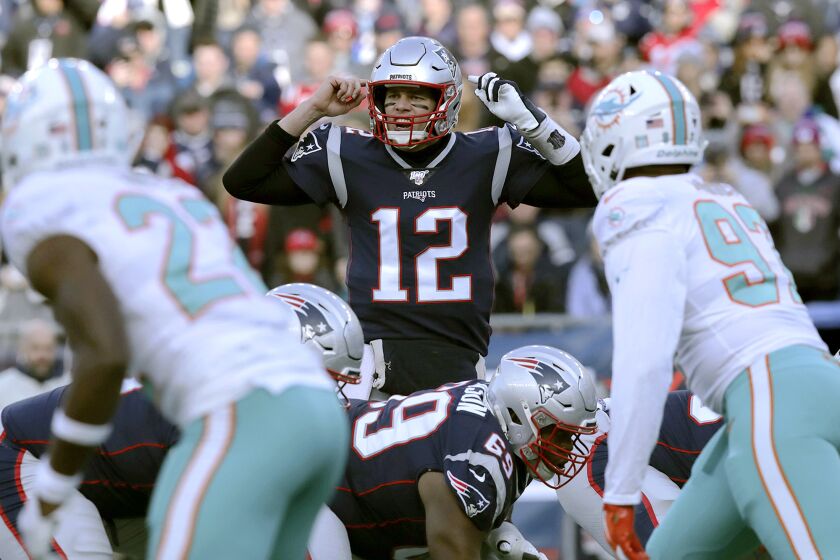 New England Patriots quarterback Tom Brady calls signals at the line of scrimmage against the Miami Dolphins in the first half of an NFL football game, Sunday, Dec. 29, 2019, in Foxborough, Mass. (AP Photo/Charles Krupa)
