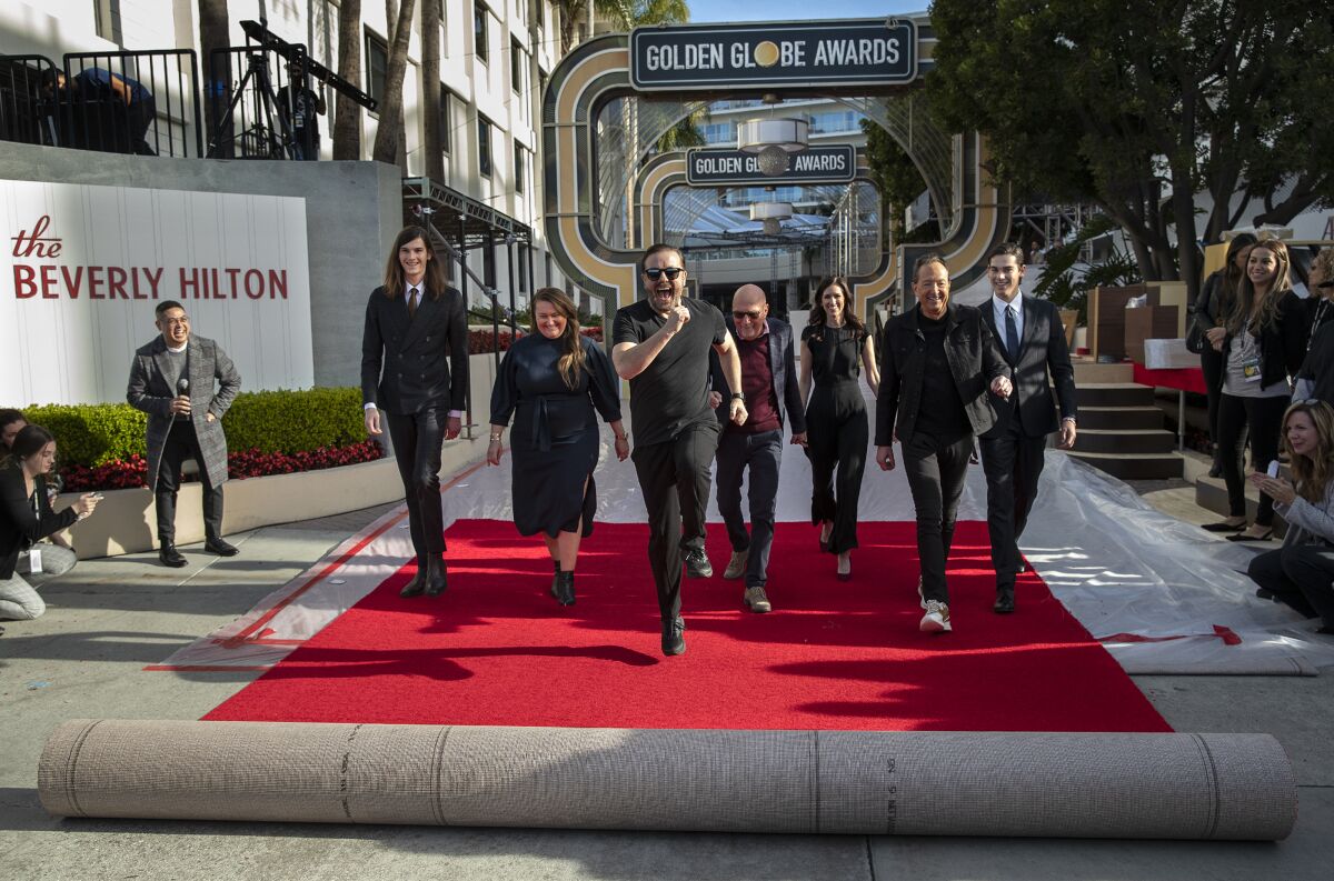 2019 Golden Globes host Ricky Gervais rolls out the red carpet in front of the Beverly Hilton Hotel.