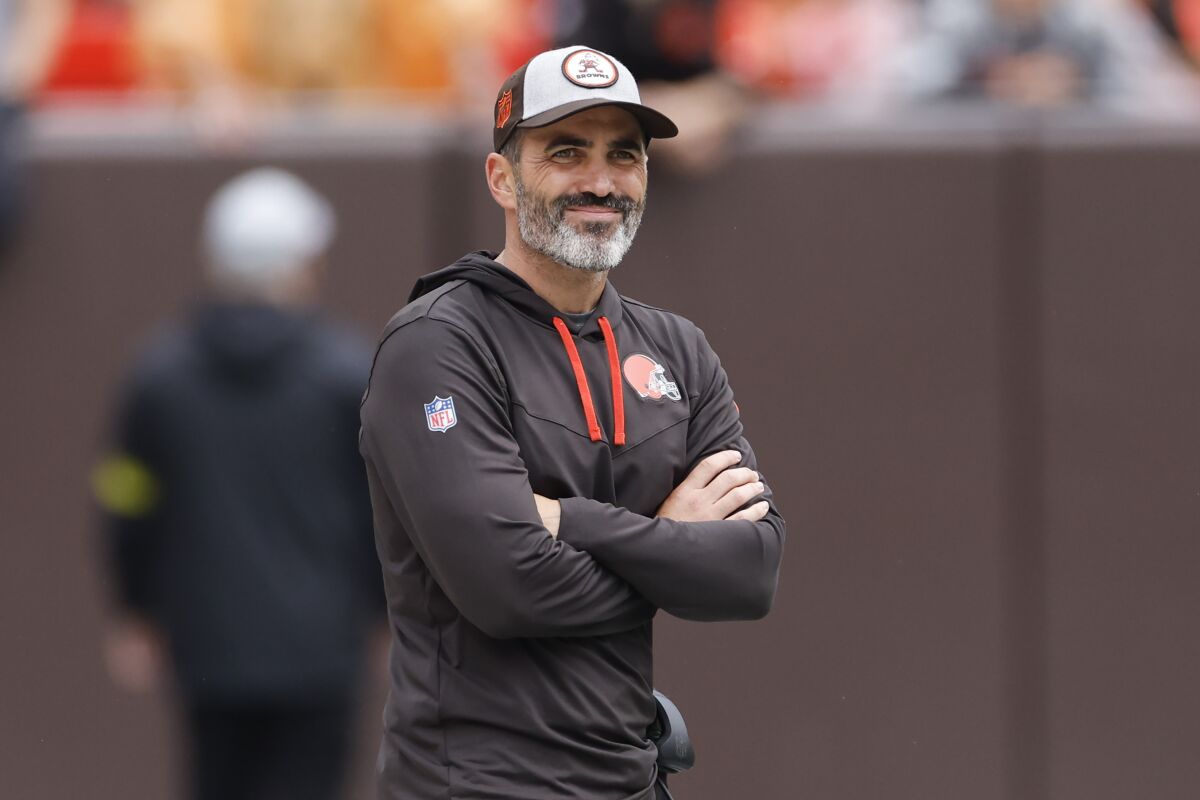 Cleveland Browns head coach Kevin Stefanski watches as his team warms up before an NFL preseason football game against the Philadelphia Eagles in Cleveland, Sunday, Aug. 21, 2022. (AP Photo/Ron Schwane)