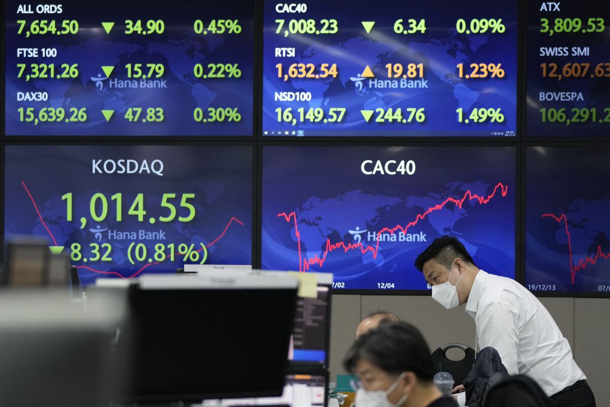 A currency trader watches monitors at the foreign exchange dealing room of the KEB Hana Bank headquarters in Seoul, South Korea, Friday, Dec. 10, 2021. (AP Photo/Ahn Young-joon)
