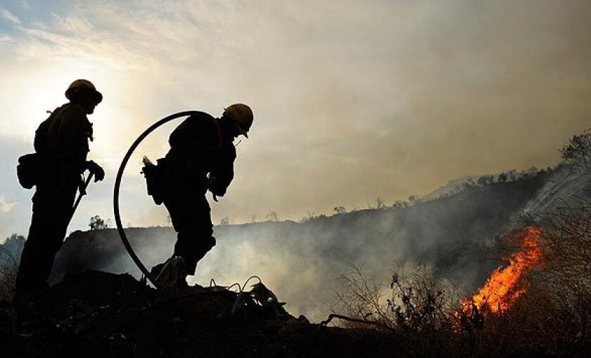 U.S. Forest Service firefighters battle the Station fire along Angeles Crest Highway in La Cañada Flintridge.